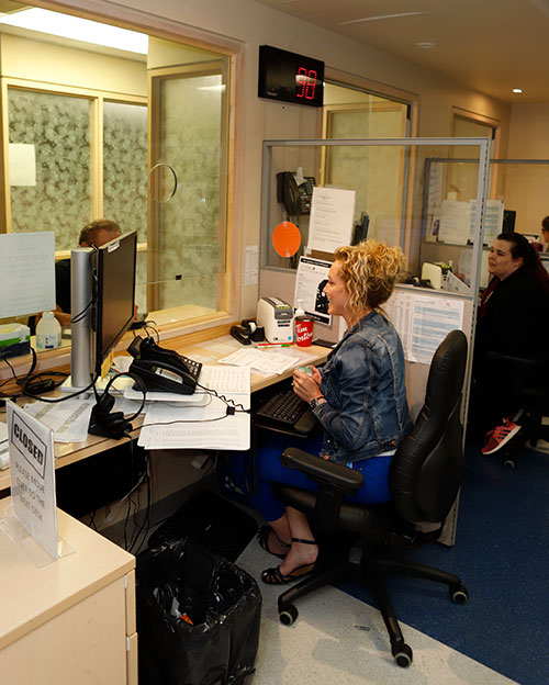 Patient and registration clerk and registration desk